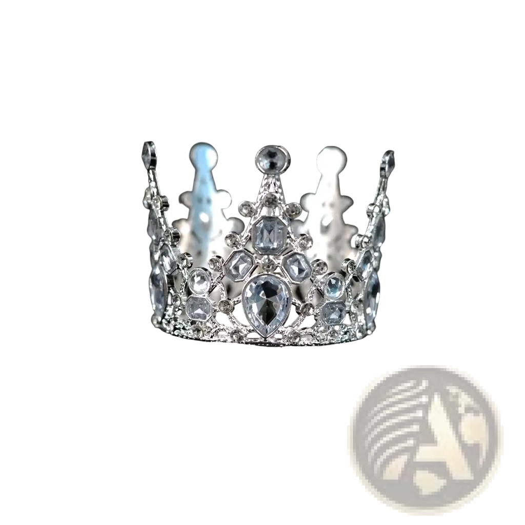 A sparkling silver mini crown cake topper and hair tiara with clear and light blue crystals and a central teardrop gemstone