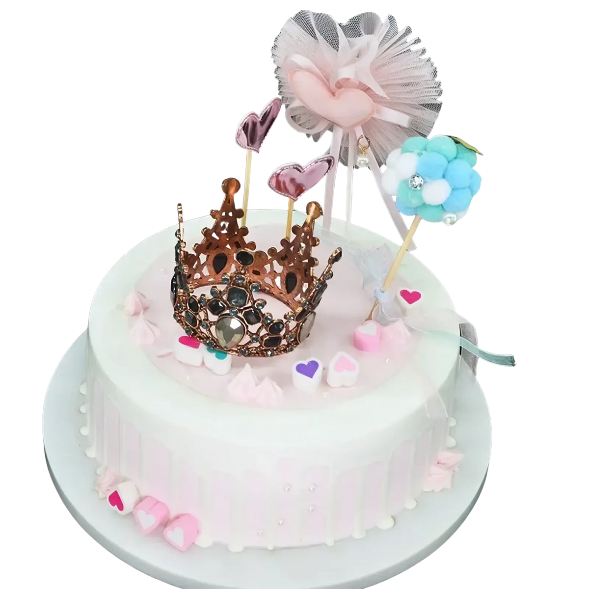 Mini crown cake topper and hair tiara with rose gold crown, pink and purple hearts, and blue white pom-pom on frosted cake