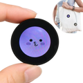 Mini gadget smart desktop companion with round black frame, glowing purple face, cute eyes, rosy cheeks, and data cable
