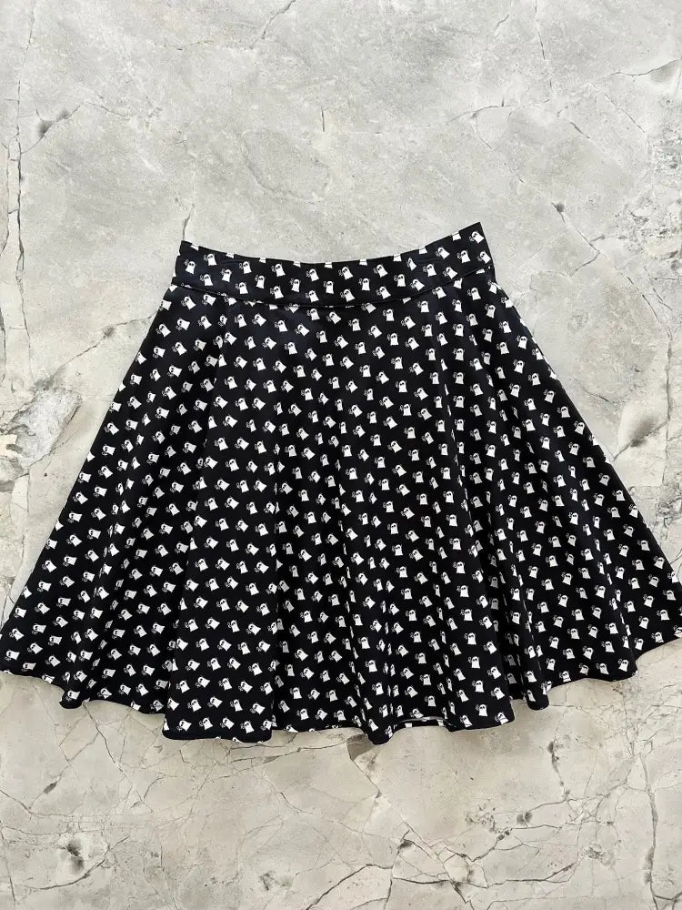 Black high waisted pleated skater skirt with repeating white ghost pattern featuring mini ghosts design