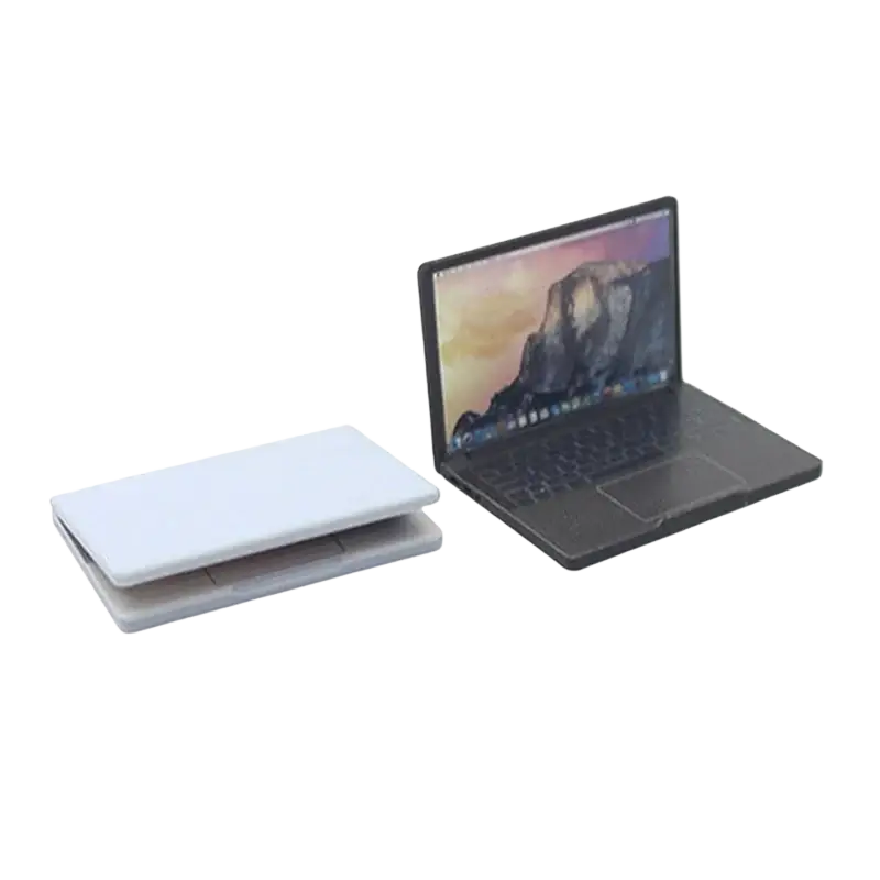 Black mini laptop with mountain wallpaper made of alloy next to two white closed laptops for doll house accessory