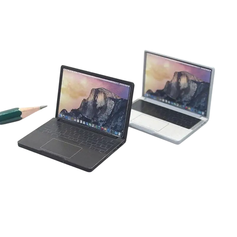 Two miniature alloy mini laptops in black and silver for doll house displaying identical mountain wallpaper screens