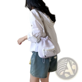White mesh drawstring crossbody bag with front zippered pocket and silver heart-shaped charm for everyday use