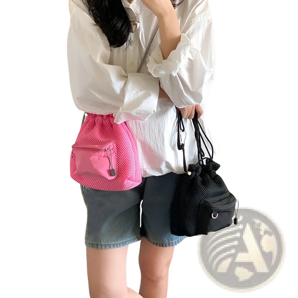 Mini pink mesh drawstring bucket bag with front zippered pocket and heart-shaped charm made of breathable mesh material