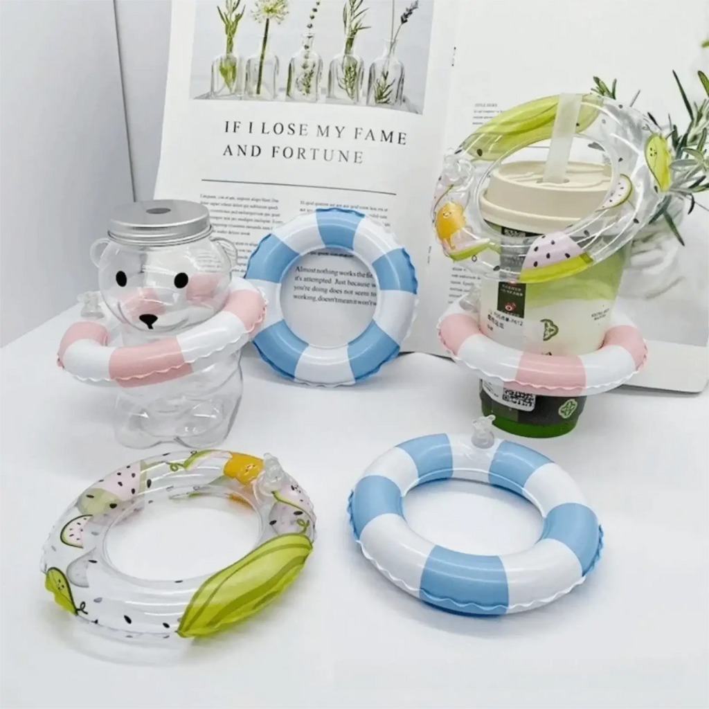 Clear plastic bear-shaped drink container with silver lid and pink inflatable ring for mini turtle swim ring toy