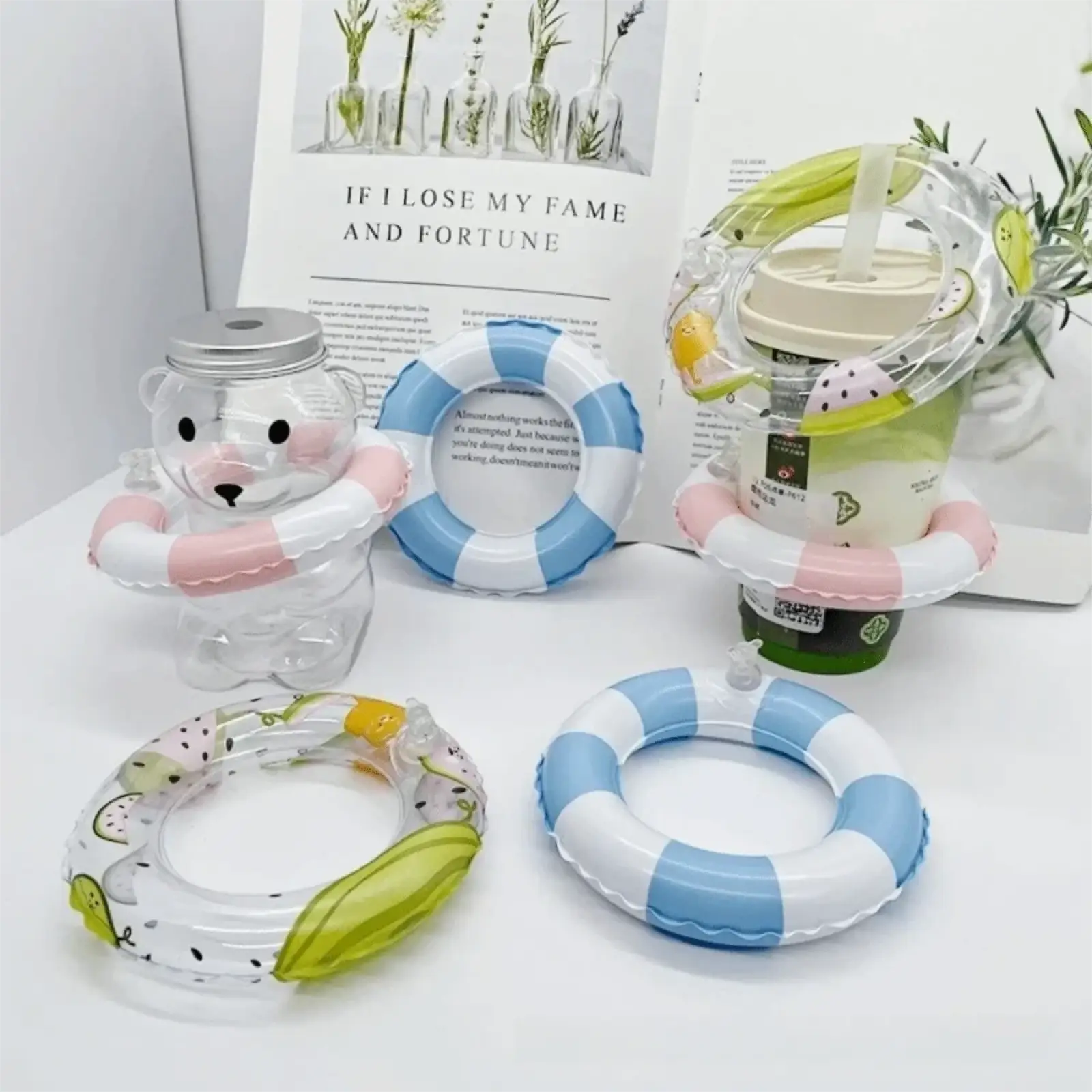 Clear plastic bear-shaped drink container with silver lid and pink inflatable ring for mini turtle swim ring toy