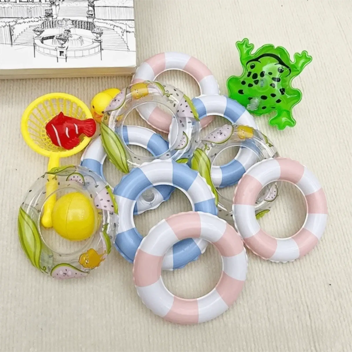 Mini turtle swimming pool float inflatable toy with pastel-striped pink white, blue white, and transparent fish designs