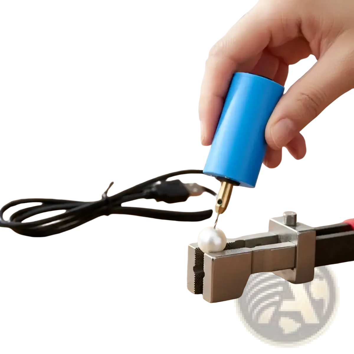 Blue mini usb electric hand drill with brass tip held over white pearl in metal vise for jewelry resin diy