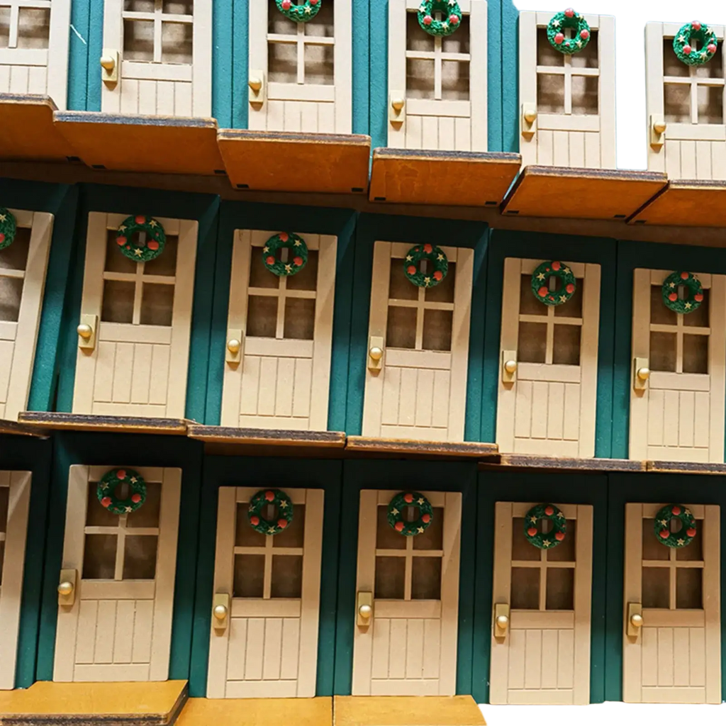 Miniature christmas door wall ornament in teal and cream with festive green wreaths on each window