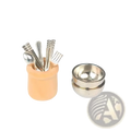 Miniature dollhouse kitchen utensil set with peach-colored ceramic holder, silver-toned cutlery, and stacked metallic bowls