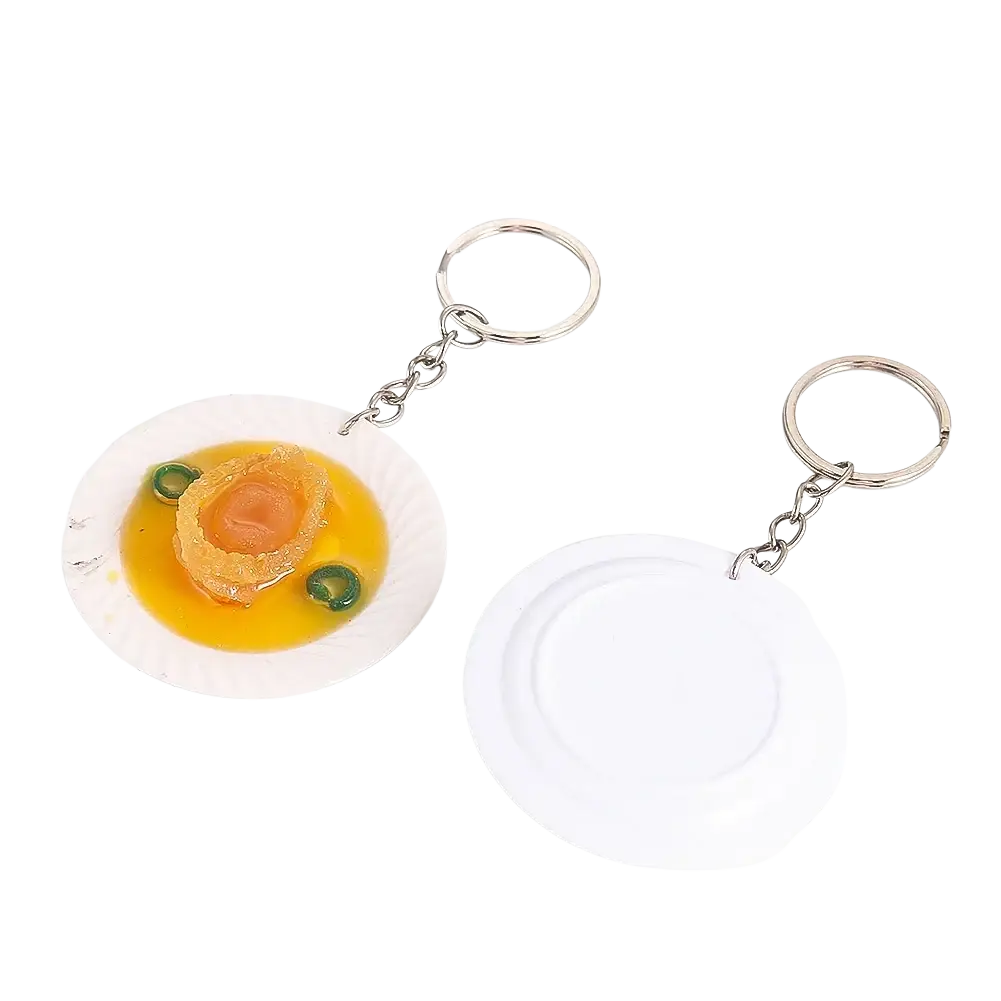 White plate keychain with miniature abalone dish featuring golden broth and green garnish for simulation display