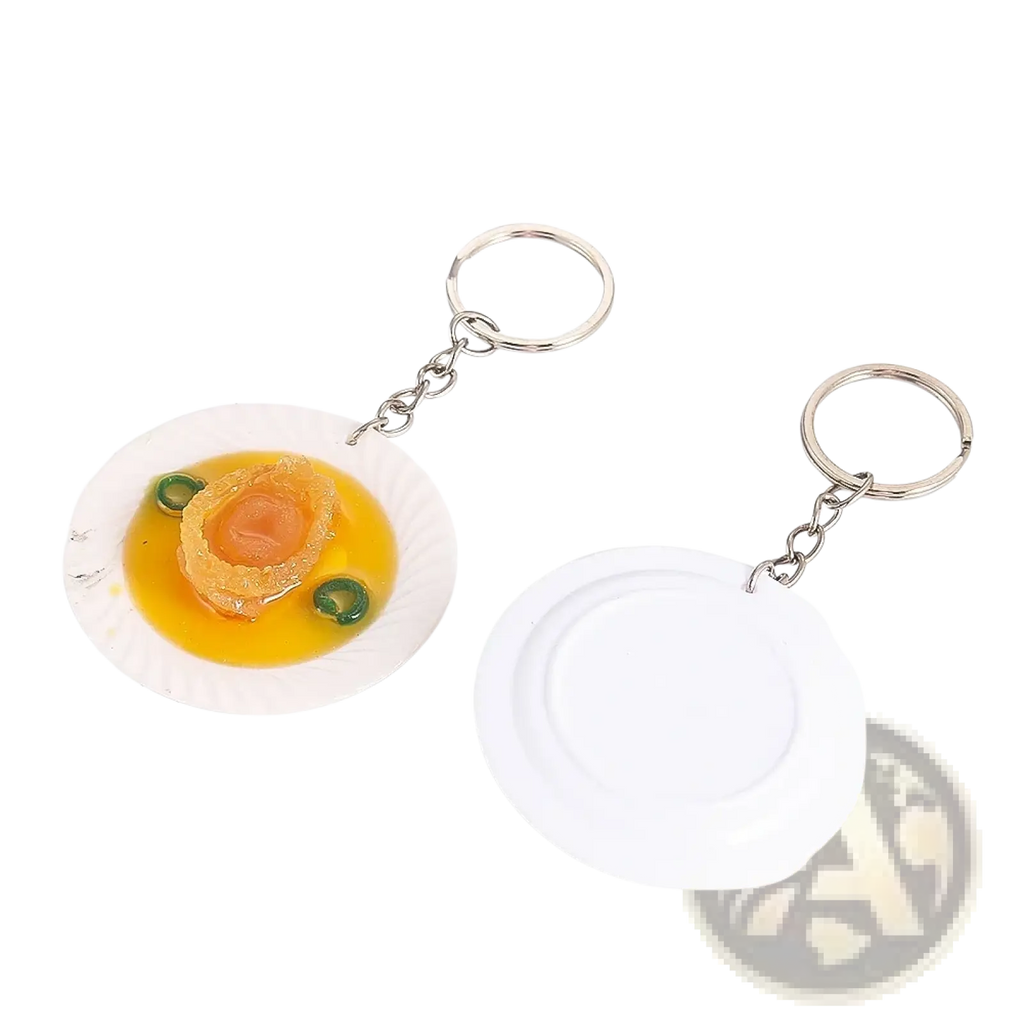 White plate keychain with miniature abalone dish featuring golden broth and green garnish for simulation display