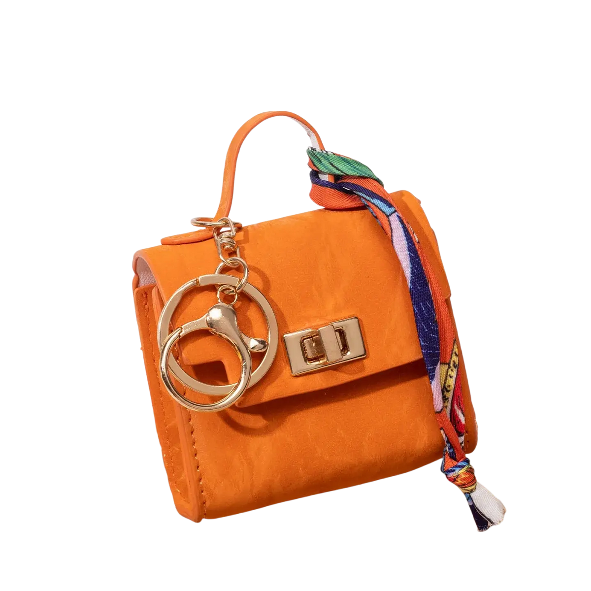Miniature orange handbag keychain with gold-tone hardware and a colorful patterned silk scarf tied on the handle