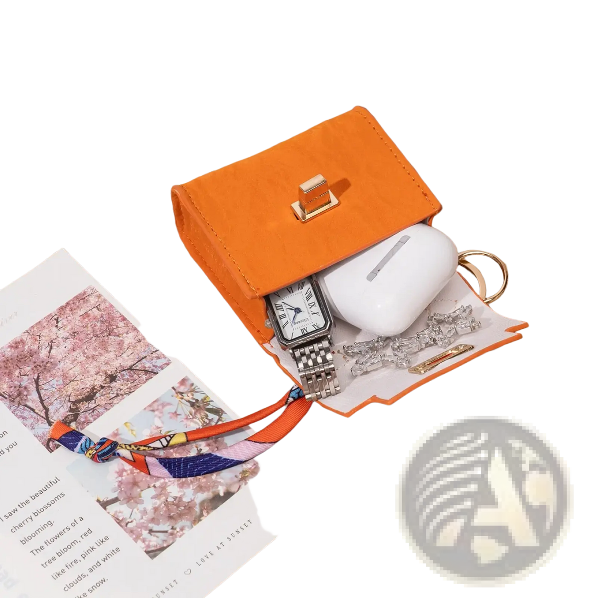 Orange faux leather miniature handbag keychain with gold-tone clasp and white interior lining featuring silk scarf