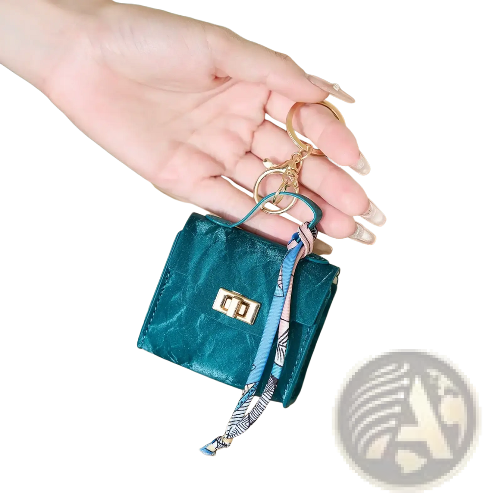 Teal miniature handbag keychain with silk scarf patterned ribbon strap and gold-tone clasp for accessory use