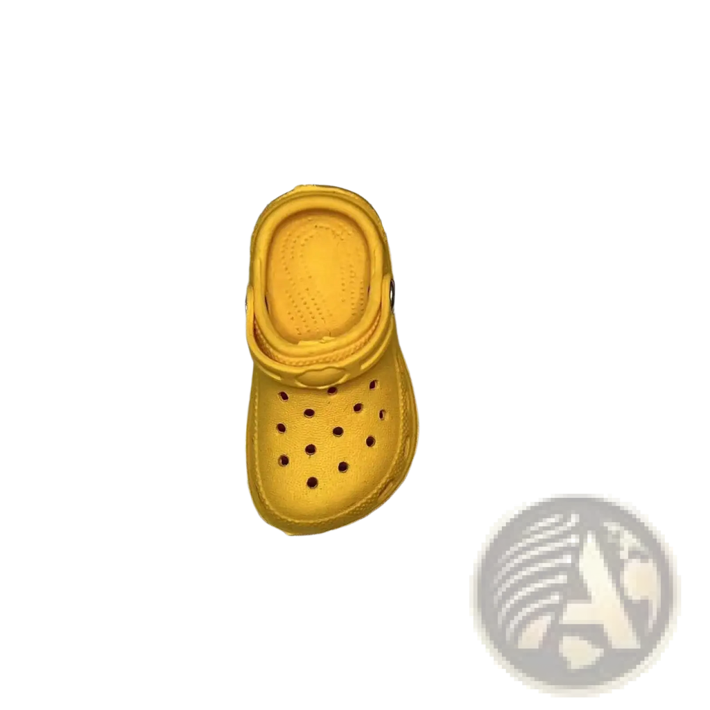 A bright yellow miniature crocs clog charm with classic perforated design and molded rubber sole for totes