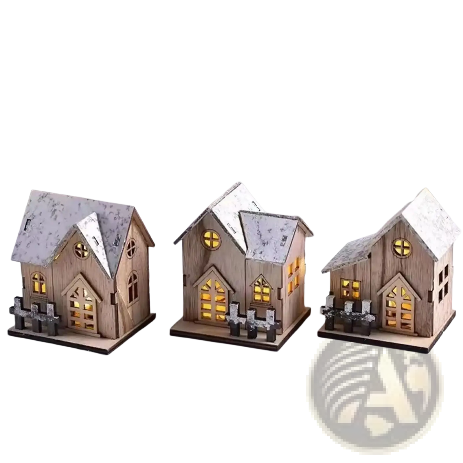 Three miniature wooden Christmas houses with snow-dusted roofs and glowing yellow lights inside
