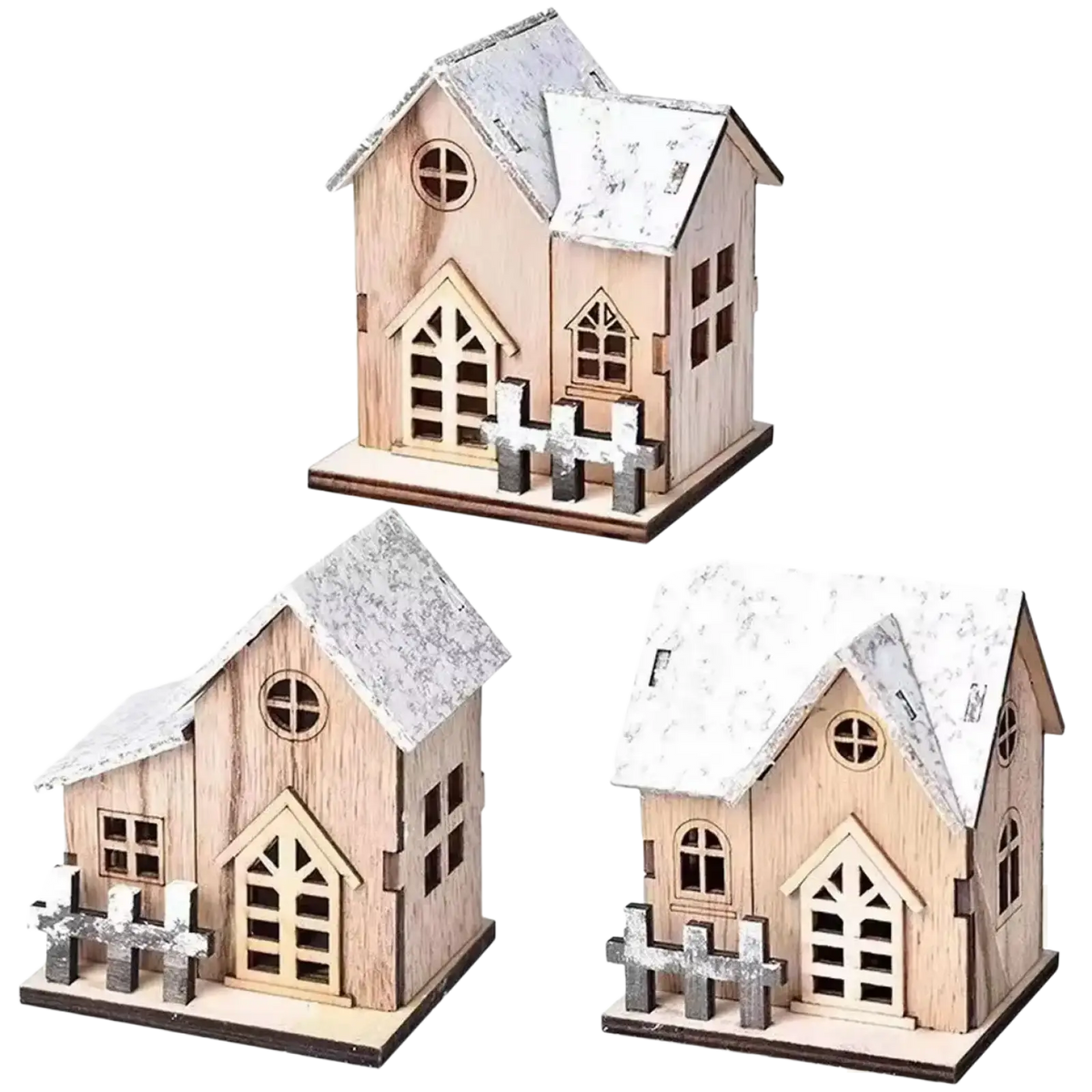 Miniature wooden christmas houses with lights featuring rustic snow-dusted roofs and decorative fences in natural wood