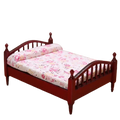 Miniature red wooden dollhouse bed with floral-patterned bedding for detailed dollhouse decor