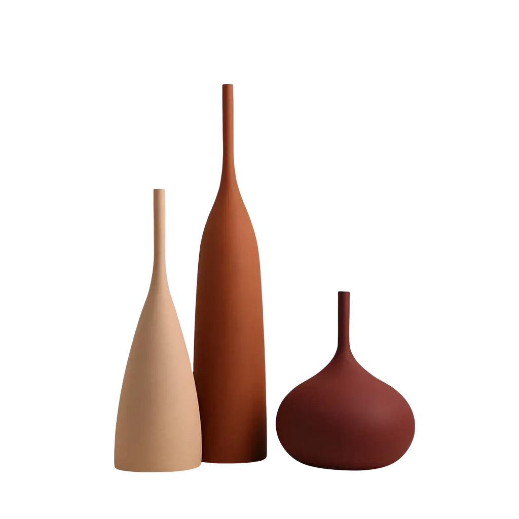 Three minimalist ceramic vases in beige terracotta and deep red with sleek modern silhouettes for wabi sabi decor
