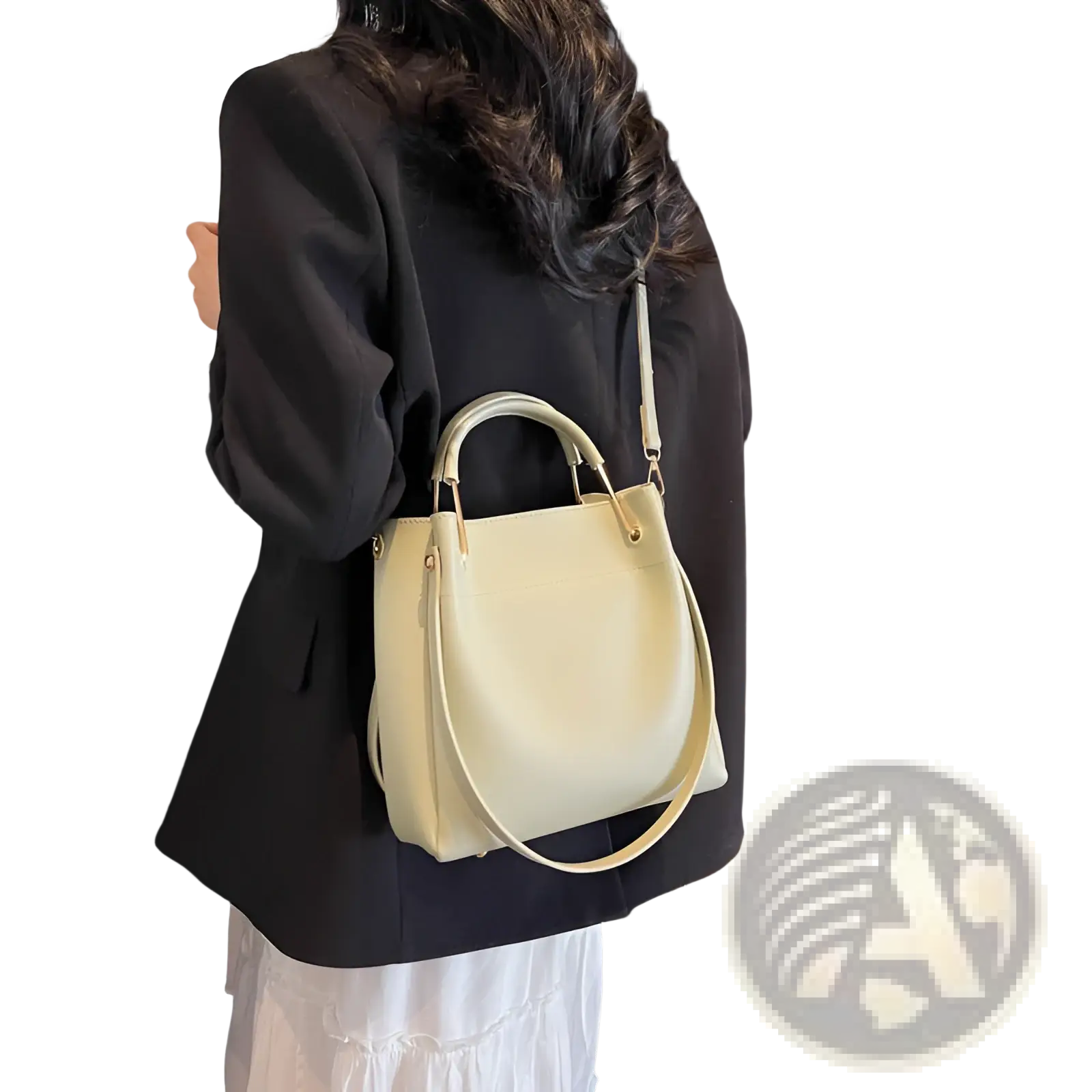 Minimalist cream-colored leather bucket bag with top handle and detachable shoulder strap for versatile use