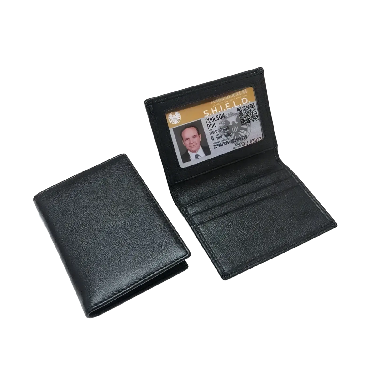 Minimalist black leather card holder slim wallet with textured surface and interior card slot holding a printed ID