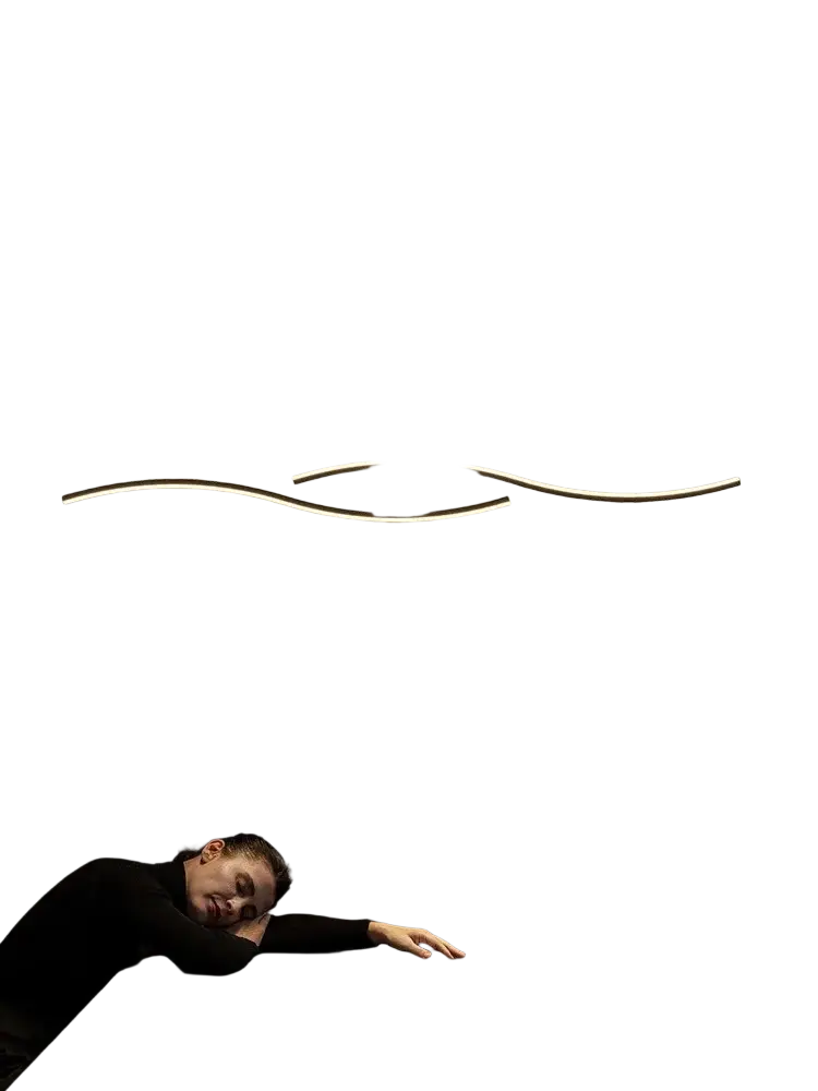 Minimalist LED wall sconce with sleek curved gold-toned metal arms and black base emitting warm ambient light