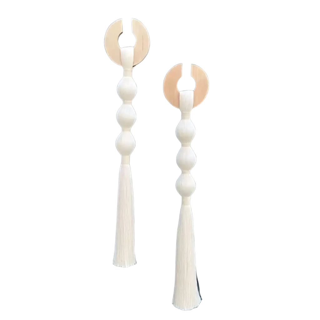 Pair of minimalist wooden wall hooks with cream-colored woven beaded stems and matching tassels for decorative hanging
