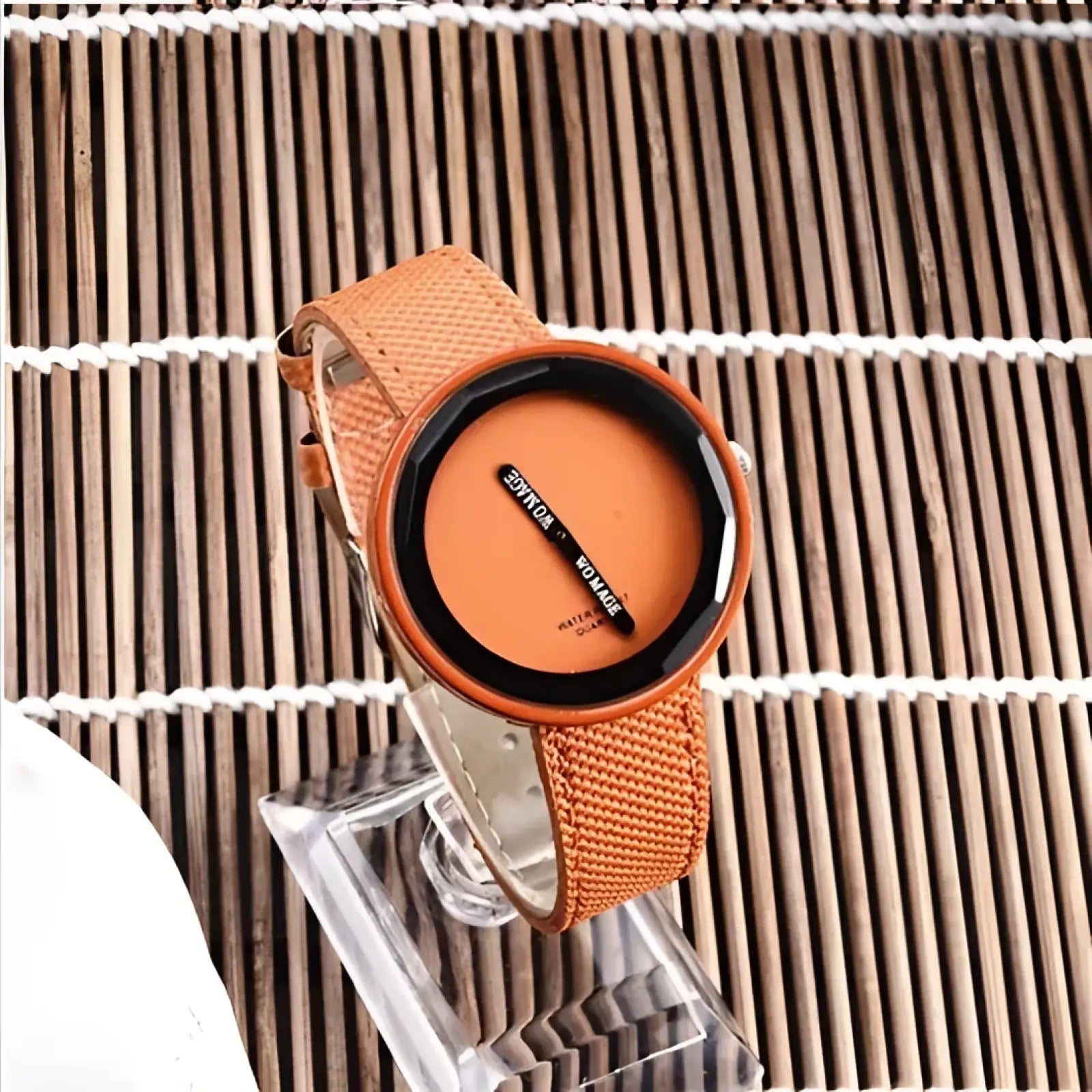 Minimalist yellow leather women’s watch with orange woven strap, black bezel, and minimalist dial