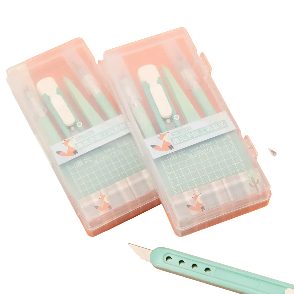 Mint craft knife set with pastel mint green blades and white handles organized in clear cases with fox-themed stickers