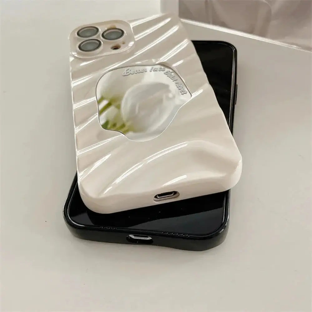 Back side of a cream-colored glossy mirror water ripple reflective phone case with sculpted waves for iPhone 14 Pro Max