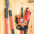 Heavy duty compact stud mounted power tool storage hook holding an orange and black Stihl gas-powered hedge trimmer