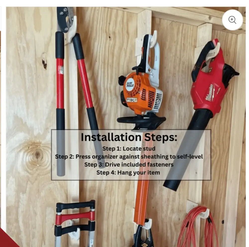 Red and black milwaukee cordless leaf blower mounted on a wooden wall using heavy duty compact stud mounted power tool storage hook