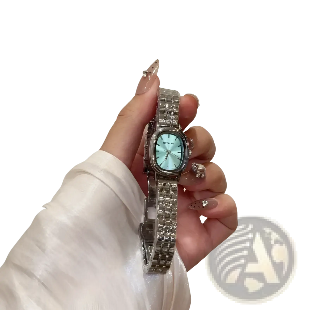 Silver minimalist Mistian oval quartz watch for women with a light blue face and diamond-encrusted rectangular case