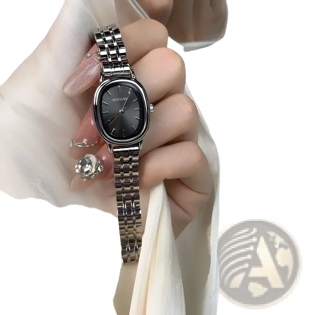 A sleek silver tone mistian oval quartz wristwatch for women with a rectangular face and minimalist dark gray dial