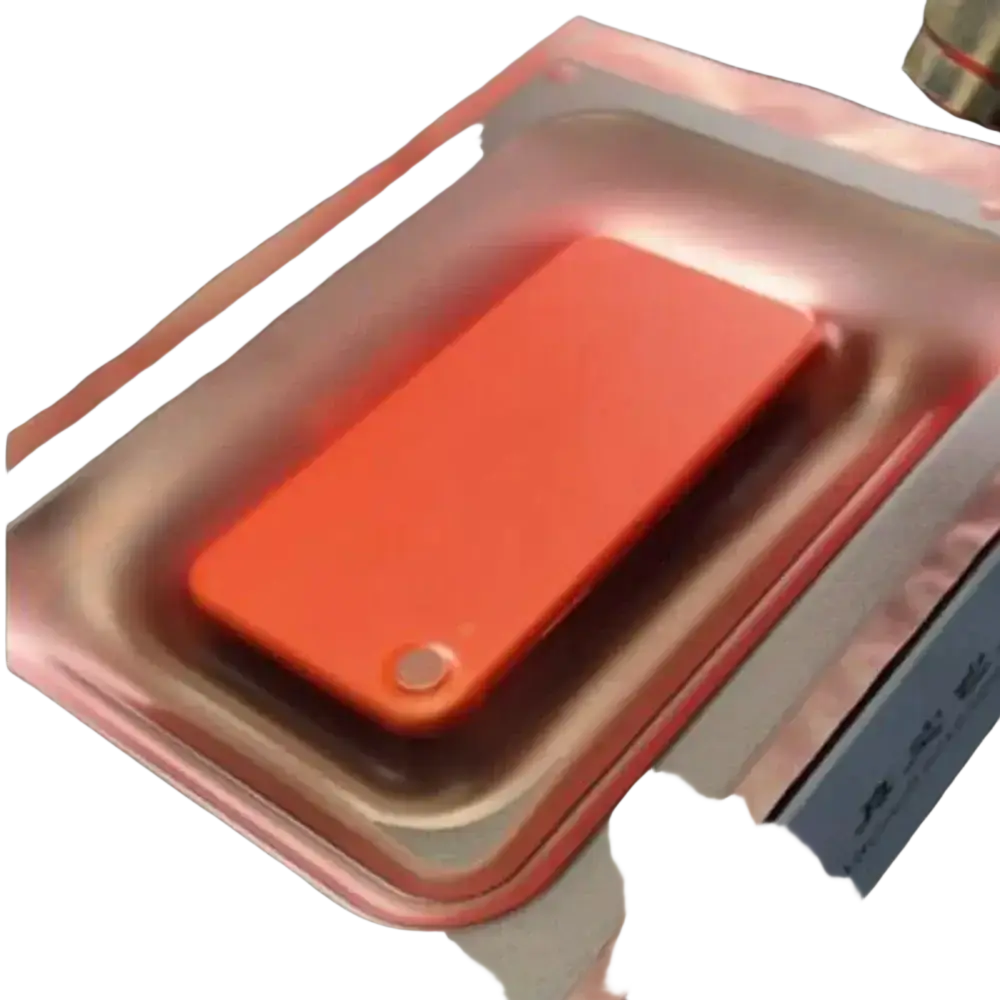 Orange rectangular power bank with circular button in metallic silver packaging for mobile phone vacuum use