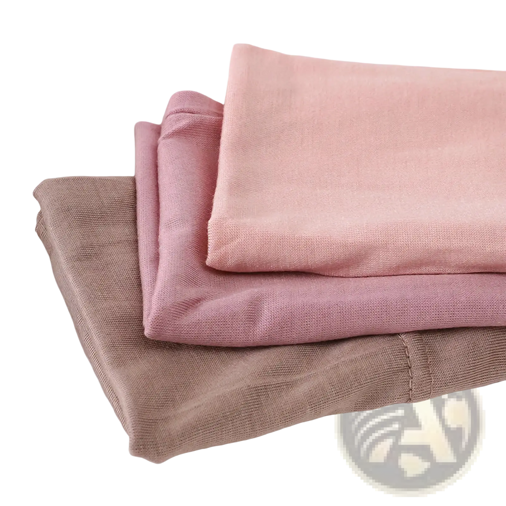 Three neatly stacked soft pastel modal cotton knit leggings in dusty rose blush pink and taupe for muslim hijab underscarf cap