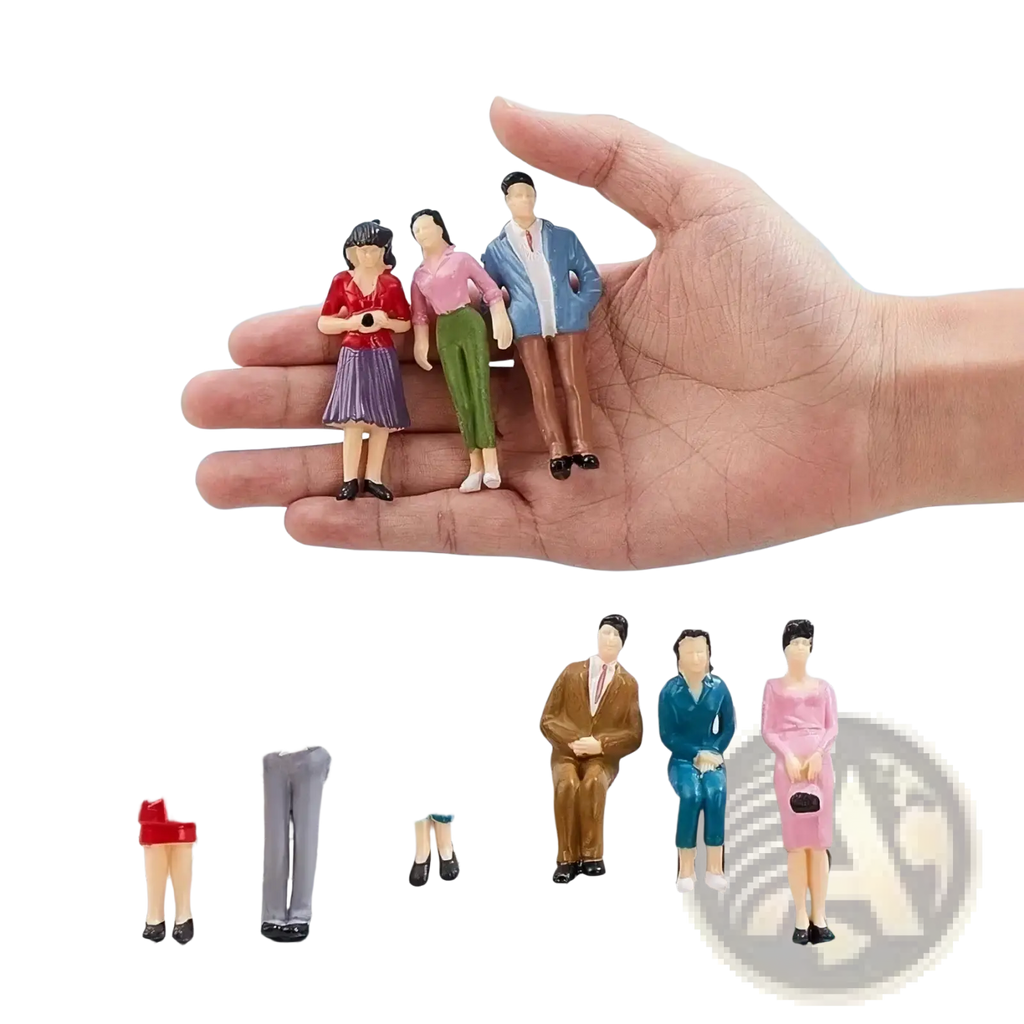 A hand holds colorful miniature plastic model train sitting passengers painted dolls for detailed layouts