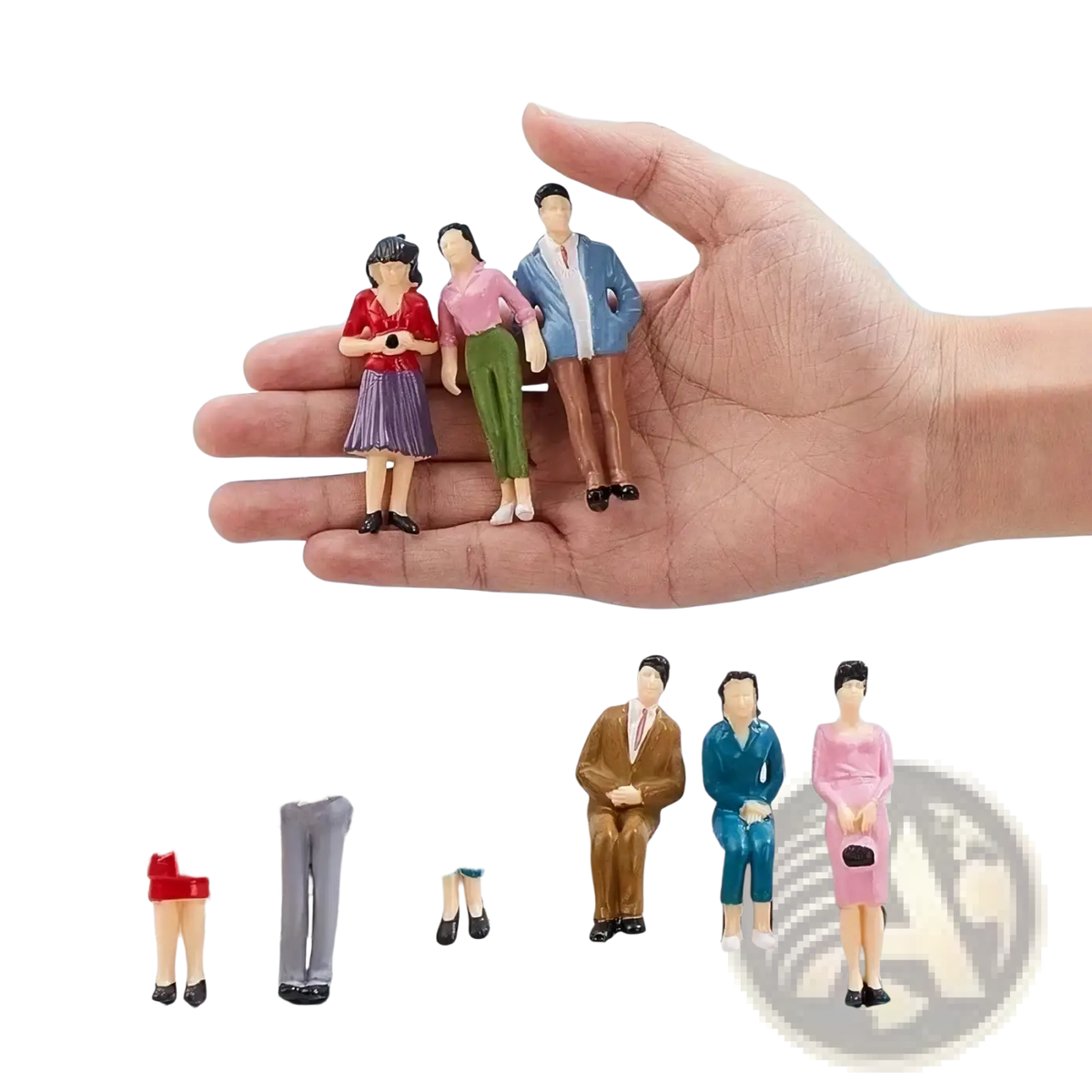 A hand holds colorful miniature plastic model train sitting passengers painted dolls for detailed layouts