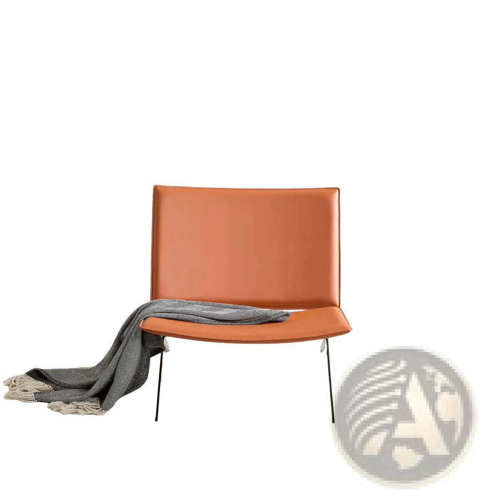 Modern accent chair in orange saddle leather with thin metal legs designed as a stylish lounge seating option