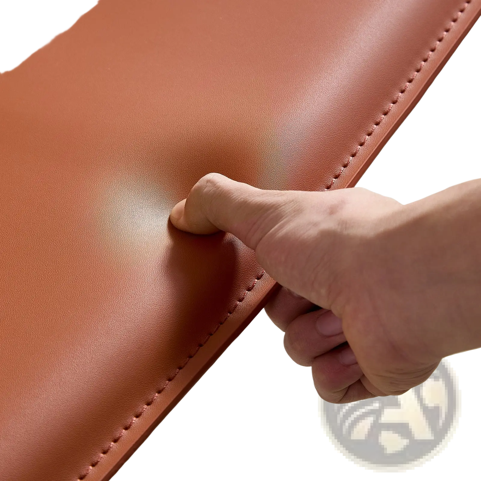 Modern accent chair in orange saddle leather with smooth tan leather laptop sleeve featuring matching stitching