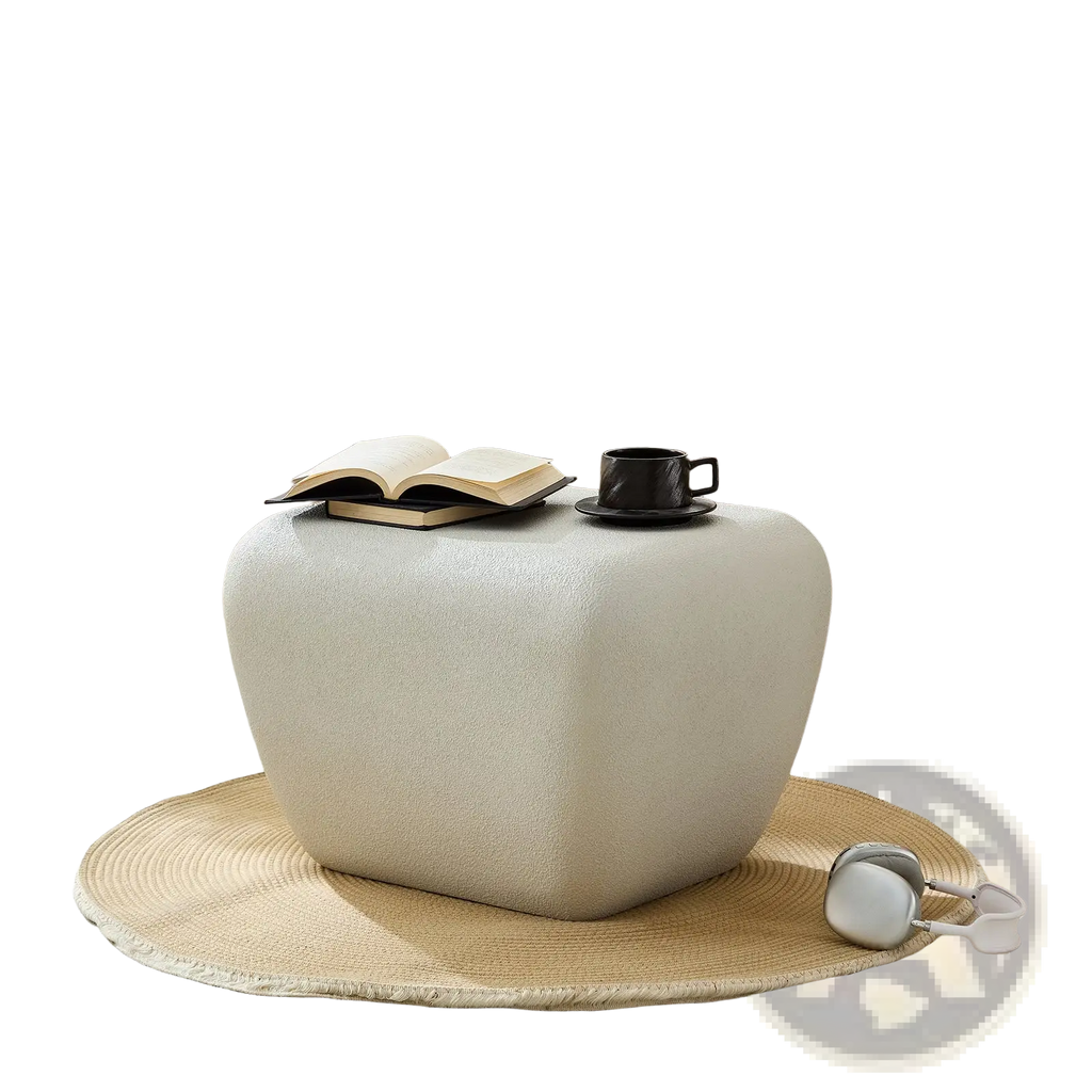 Cream-colored textured fabric ottoman with rounded edges and modern minimalist design as an accent coffee table