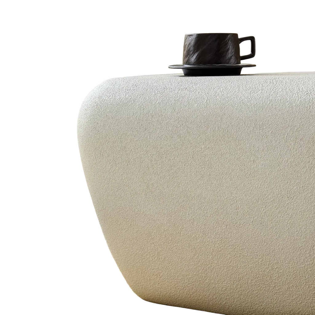 Modern accent coffee table in cream color with textured surface and matte finish ideal for stylish living spaces