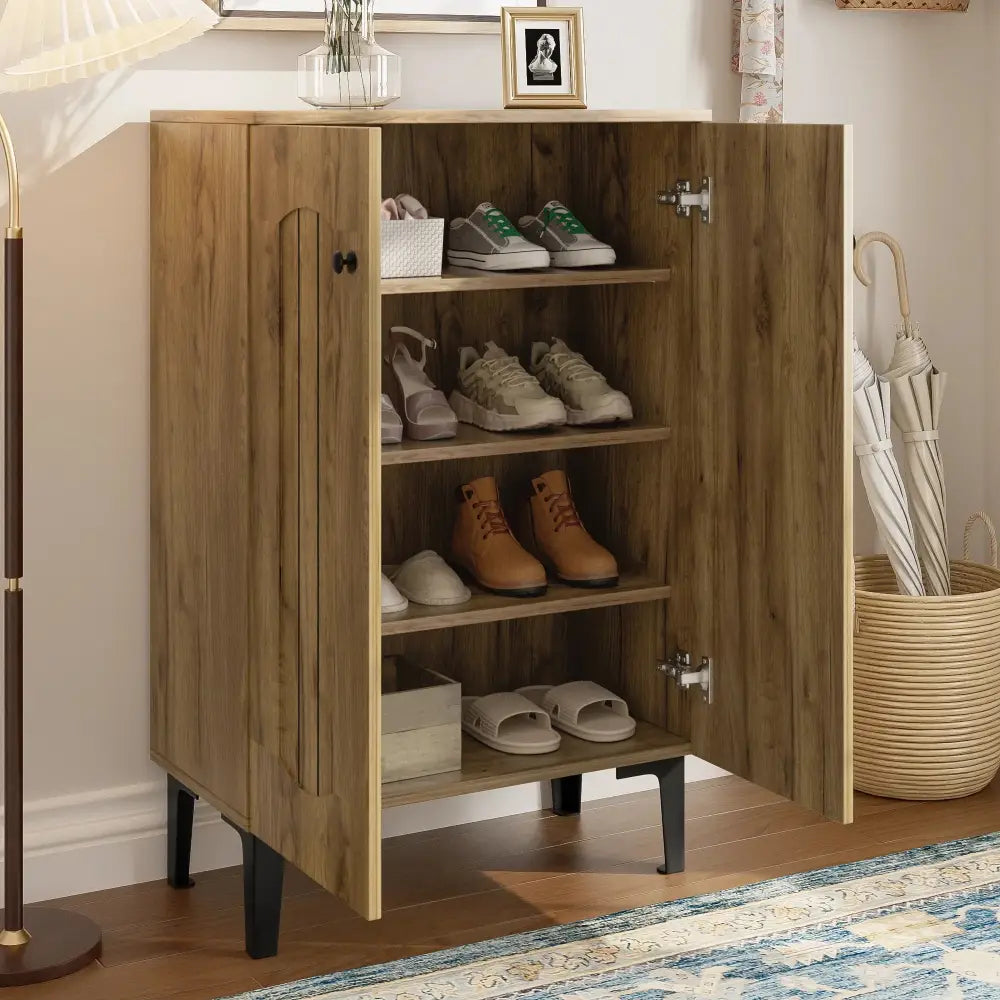 Wooden shoe cabinet with light brown double doors, black metal legs and handles for modern storage solutions