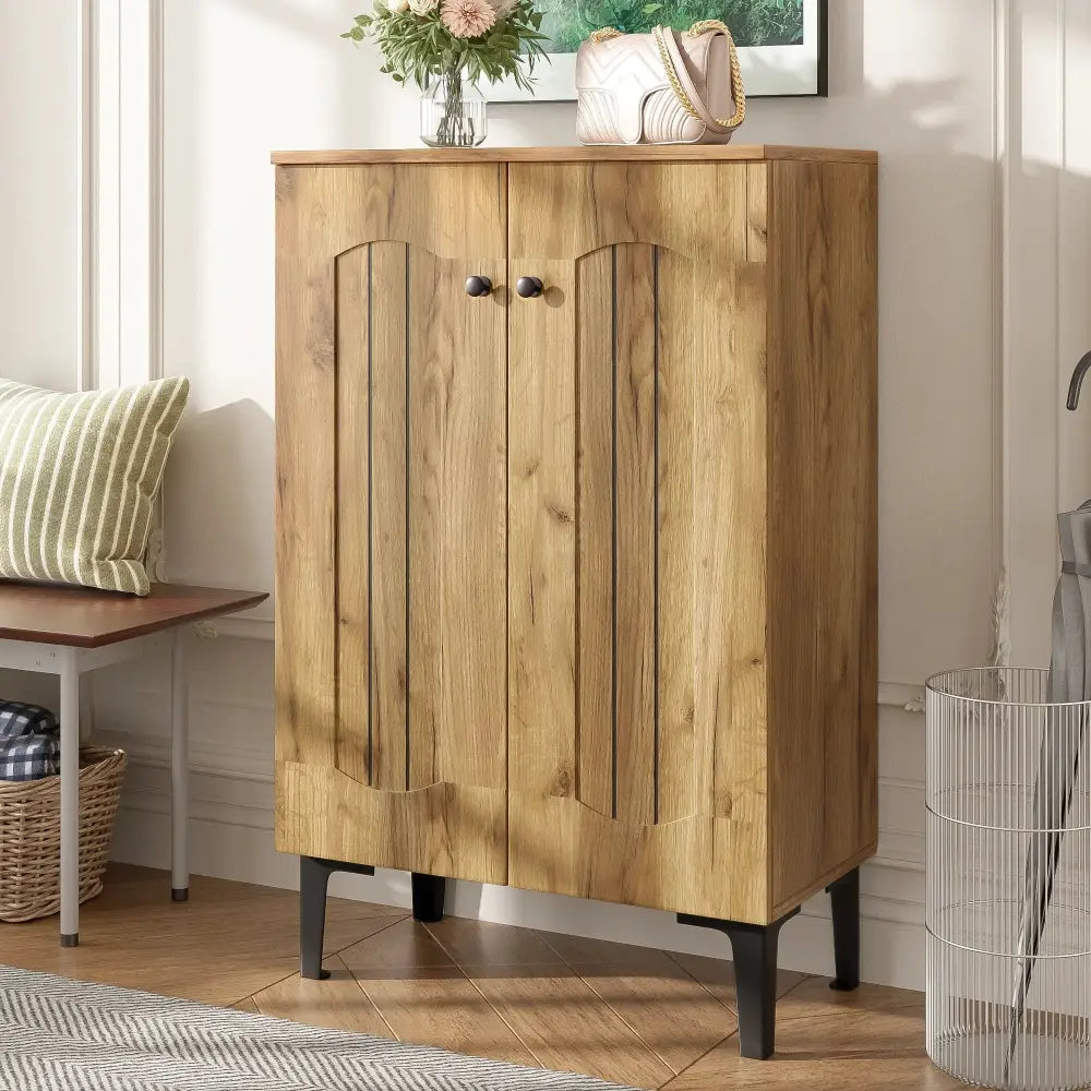 Modern light brown double door shoe cabinet with arched wooden doors and black metal legs for stylish storage