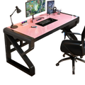 Modern glass office desk with pink glass top and black frame featuring storage shelves for organized workspace