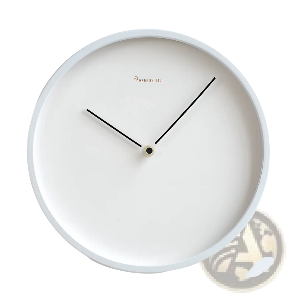 Modern minimalist metal wall clock features a white face with sleek black hands and a subtle made by mjk logo