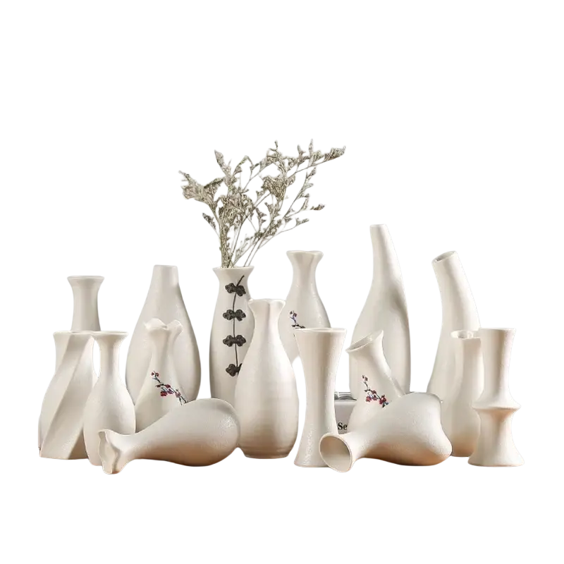 Modern white ceramic vases with varying shapes and subtle floral decals arranged on a wooden surface for decor