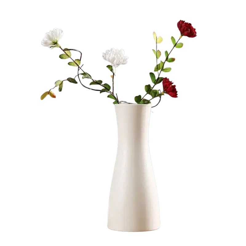 A sleek modern white ceramic vase with a slender flared silhouette holds white and red artificial flowers