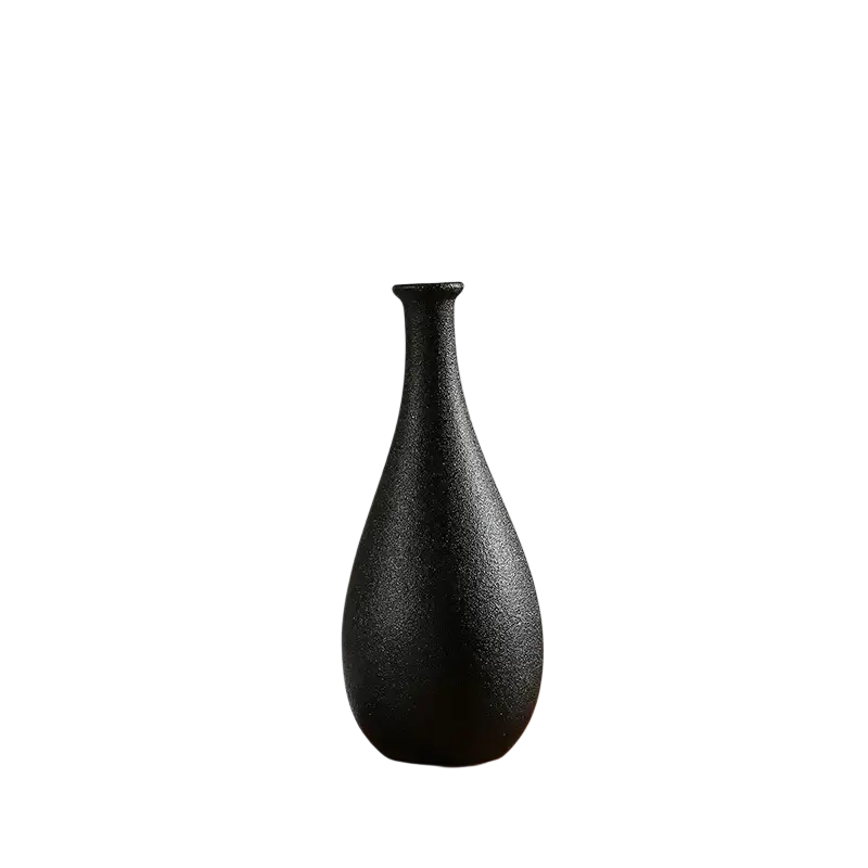 A sleek black ceramic vase with a textured matte finish and slender neck for modern white ceramic floral decor